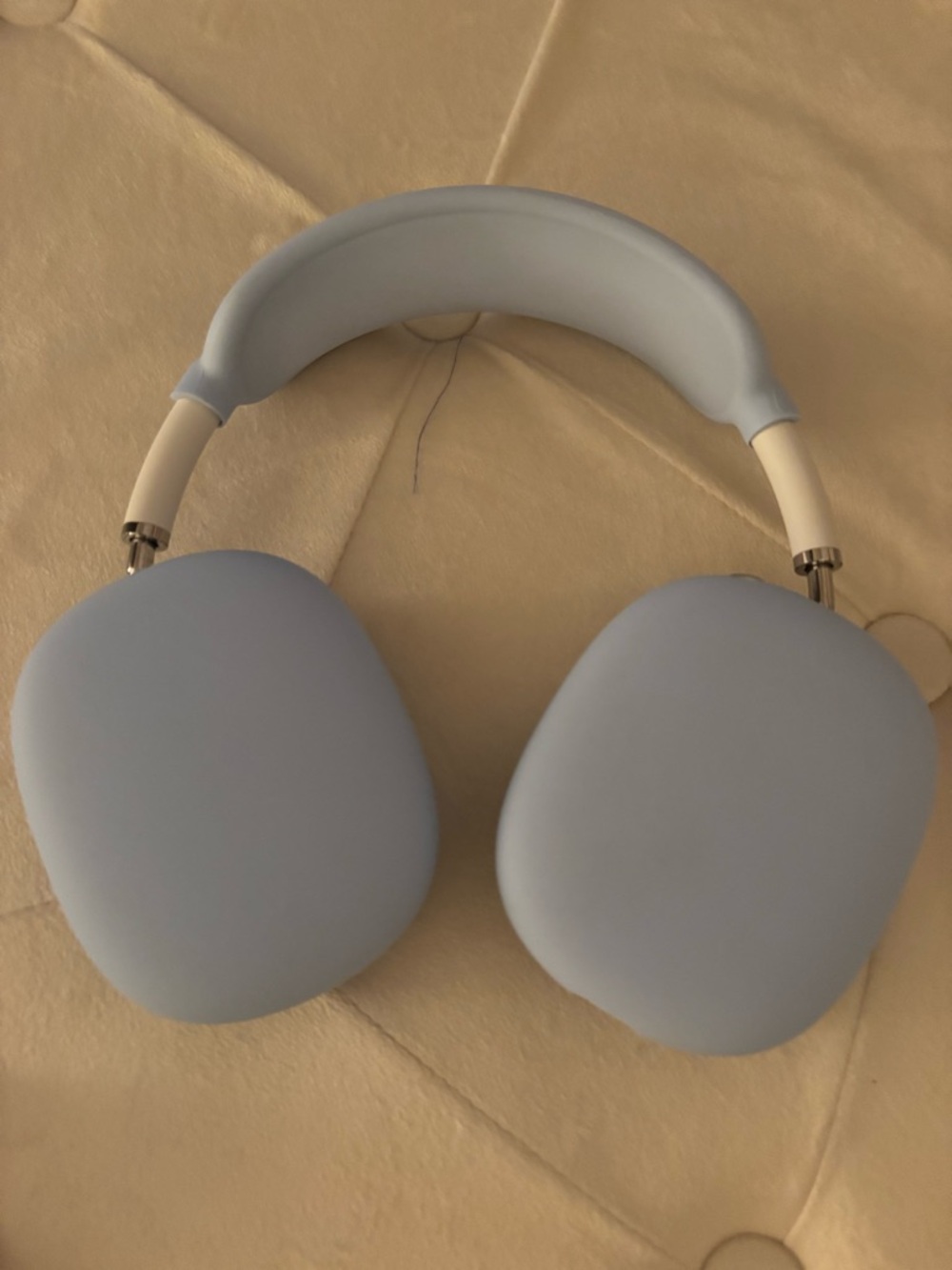 White AirPod Max with Blue protective coverings and blue ear pieces